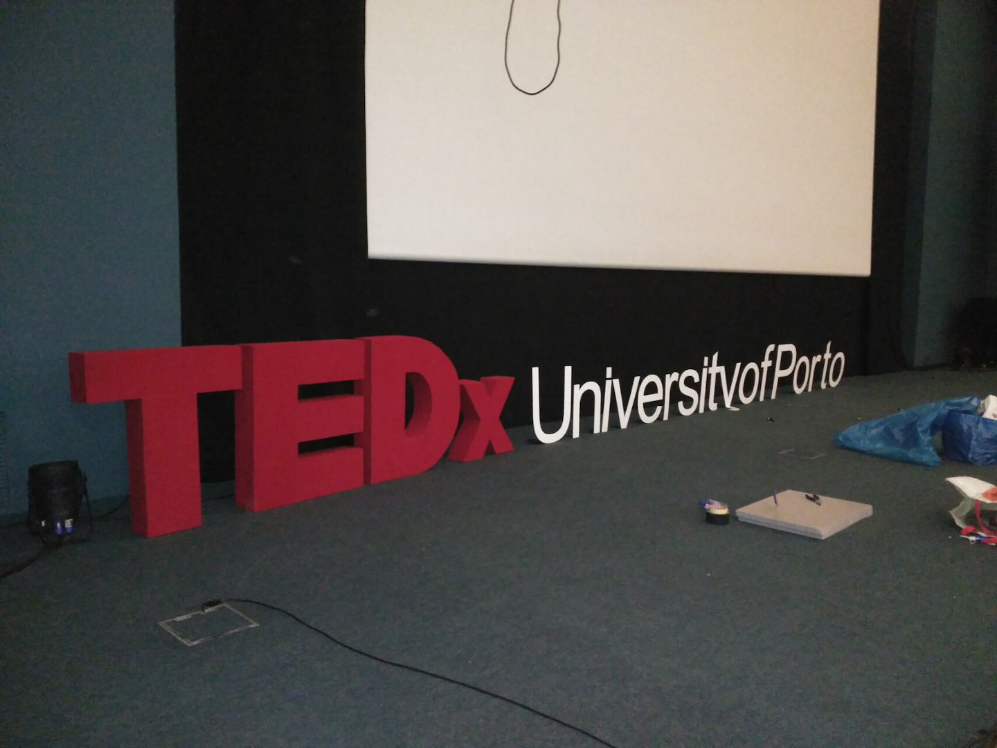 Building the TEDx University of Porto Stage Logo ||
          For the TEDx event at the University of Porto, I undertook the task of constructing the stage logo. The logo
          was crafted from several foam sheets, which were glued together and then covered with cardboard for additional
          structure and stability. The final step in the construction process involved painting the assembled logo in
          the traditional TEDx colors.
          In order to cut the foam sheets. I created a homemade cutting device using a heat wire extracted from a hair dryer, which was then powered by a transformer
          from an old laptop. This setup effectively heated the wire, allowing it to cut through the foam with
          precision.
          Apart from the construction of the logo, I was also involved in the broader organizational aspects of the TEDx
          event.